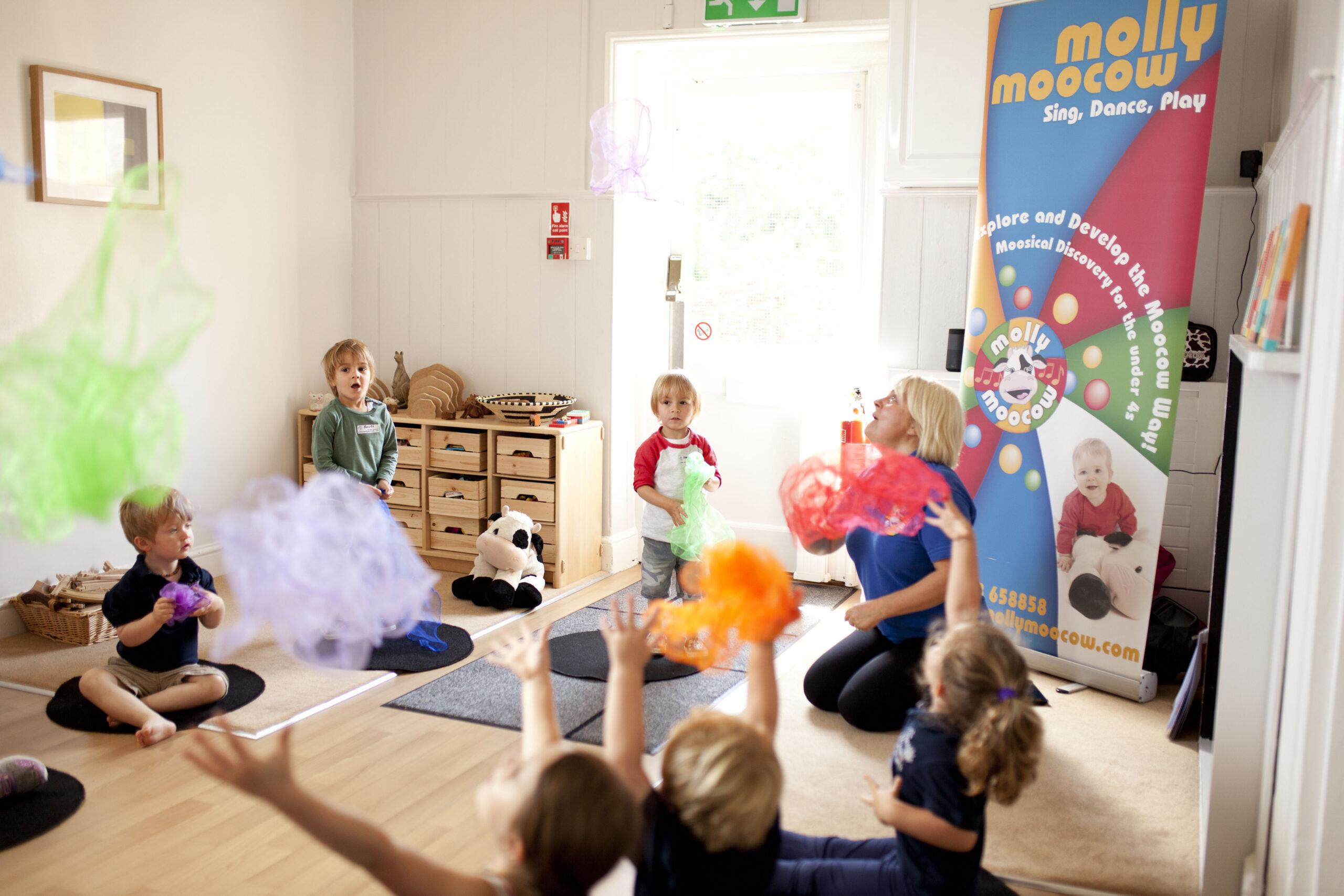 Children playing with scarfs in a Molly Moocow class