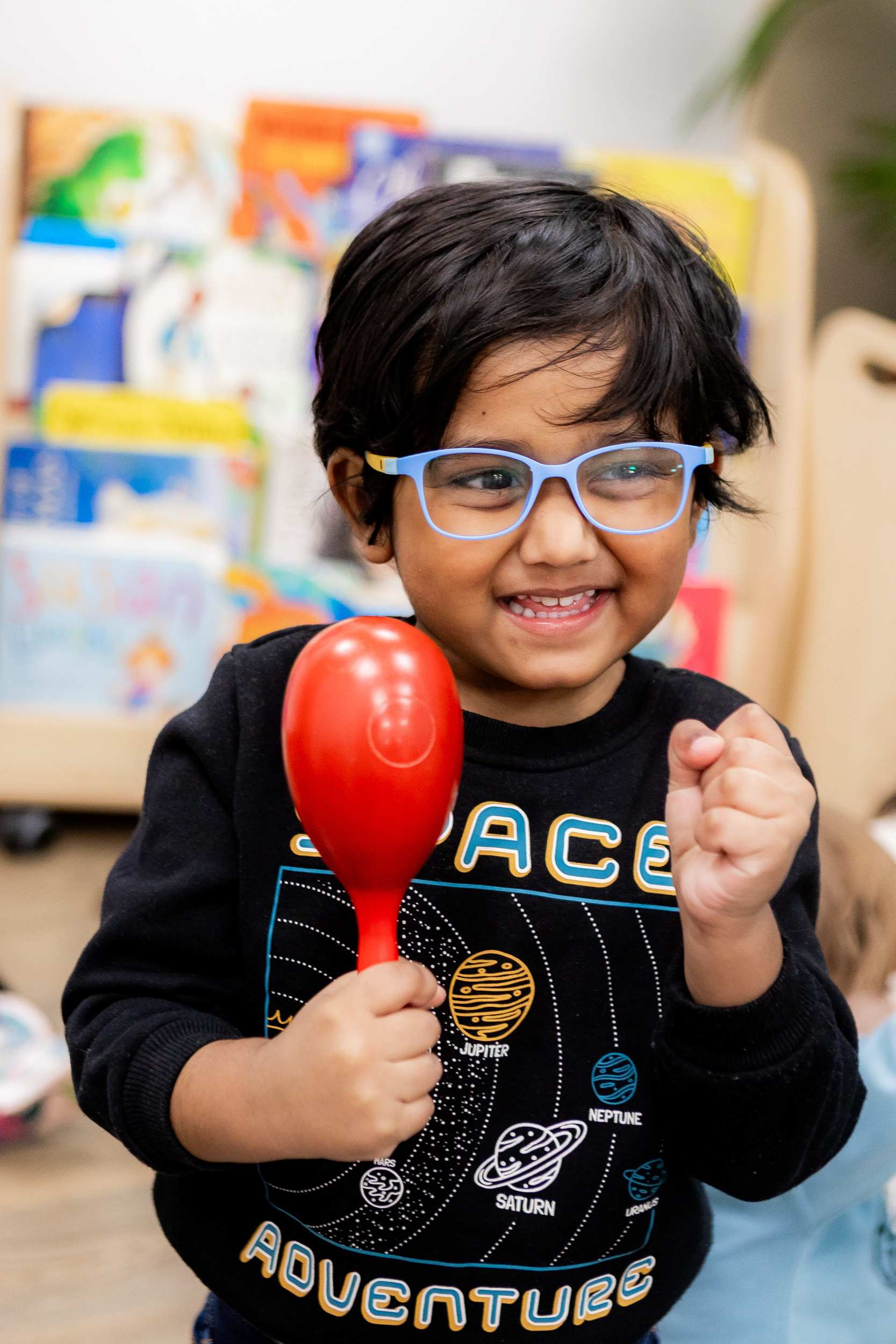 Child with Maraca at Molly Moocow class
