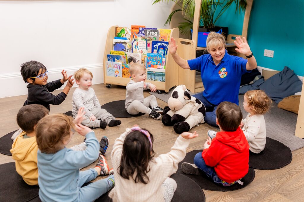 Toddlers joining in with Molly Moocow and teacher