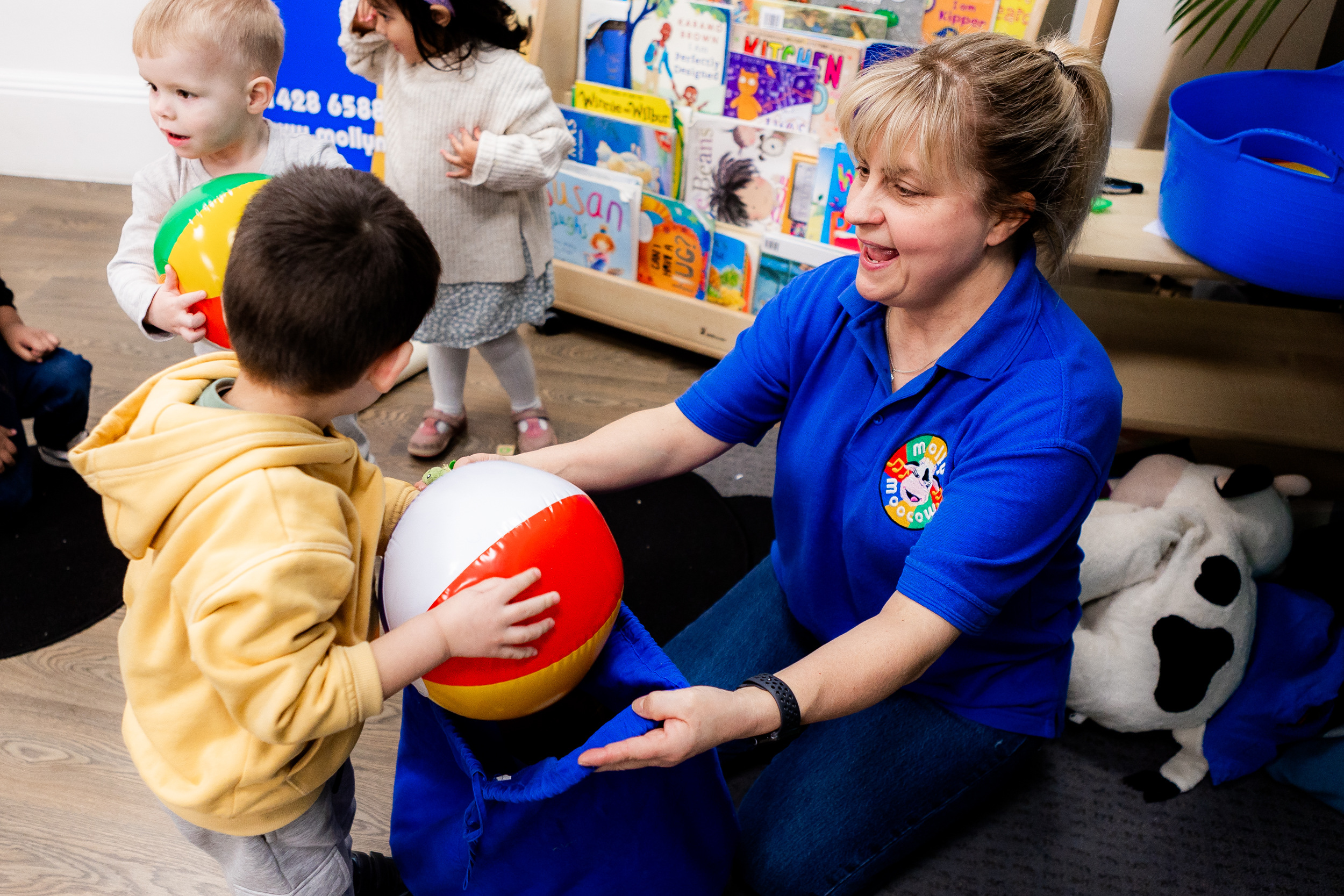 A child with a beach ball in a Molly Moocow class